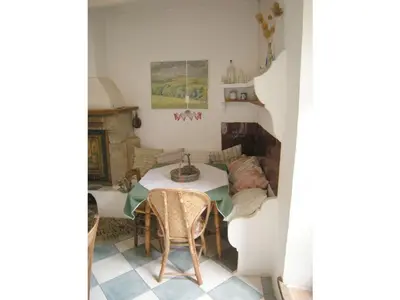 a dining room with a table and a fireplace at Maison de Maitre Comfortable holiday residence in Ferrals-lès-Corbières