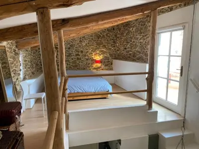 a bedroom with a bunk bed and a window at Red sun and green tea in Saint-Jean-de-Barrou