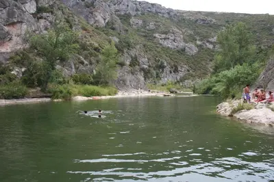 a group of people swimming in a river at Red sun and green tea in Saint-Jean-de-Barrou