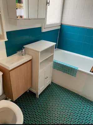 a bathroom with a toilet and a tub and a sink at L'Escale Marine in Gruissan