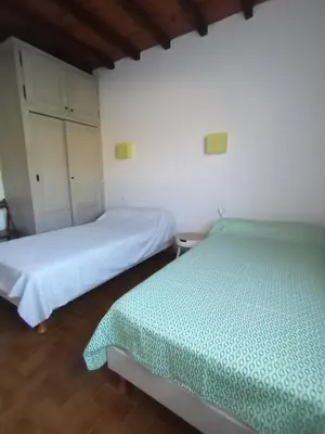 two beds in a room with white walls at Charmant gîte au coeur des Corbières in Tuchan