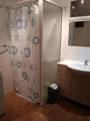 a bathroom with a shower curtain and a sink at Charmant gîte au coeur des Corbières in Tuchan