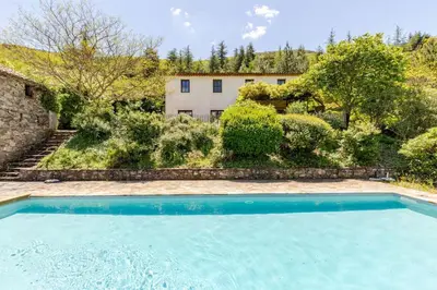a swimming pool in front of a building at Stylish villa with large pool and stunning views in Olargues