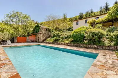 a swimming pool in the backyard of a house at Stylish villa with large pool and stunning views in Olargues