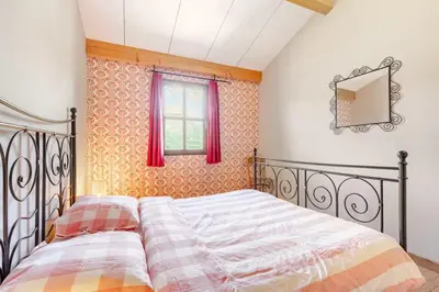 a bedroom with a bed and a window at Stylish villa with large pool and stunning views in Olargues