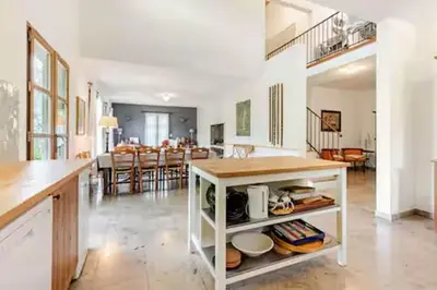 a kitchen and dining room with a table and chairs at Stylish villa with large pool and stunning views in Olargues