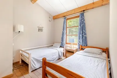 two beds in a room with a window at Stylish villa with large pool and stunning views in Olargues