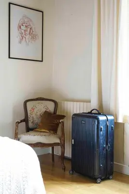 a bedroom with a bed and a table and chairs at Le Presbytère de Bugarach in Bugarach