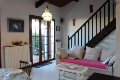 a living room with a couch and a staircase at Maison 4 pièces 8 couchages PORT LA NOUVELLE PN000-001 in Port-la-Nouvelle