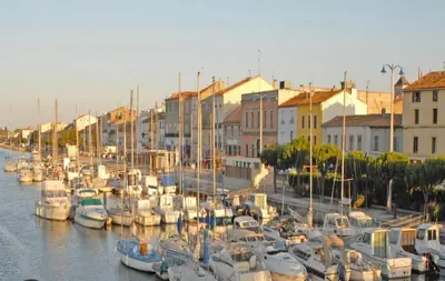 a bunch of boats docked in a harbor with buildings at LE LOGIS, T2 au pied de la plage, Climatisation in Port-la-Nouvelle