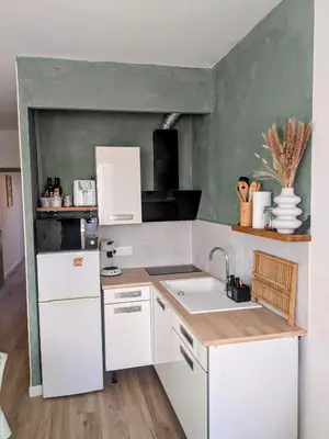 a kitchen with white cabinets and a sink at LE LOGIS, T2 au pied de la plage, Climatisation in Port-la-Nouvelle
