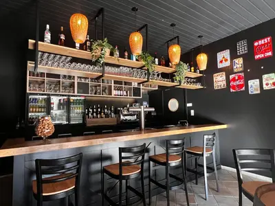 a bar with stools in a restaurant at Domaine de l'Espinet in Quillan