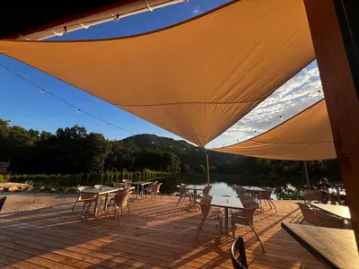 a group of tables and chairs on a patio at Domaine de l'Espinet in Quillan