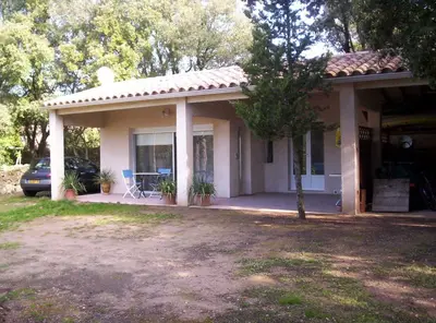a house with a car parked in front of it at Manor Norbert in Ventenac-Cabardès