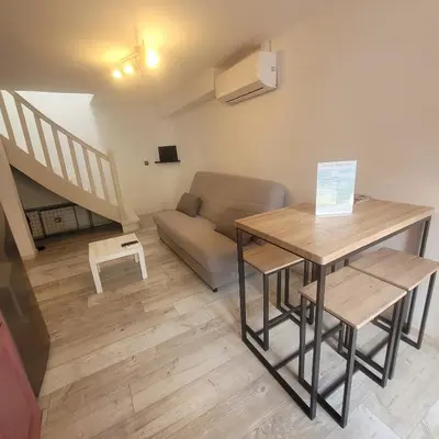 a living room with a table and a couch at Détente et plaisir à Taltahull in Tautavel