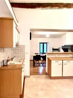 a kitchen and dining room with a table in it at Appartement centre-ville in Carcassonne