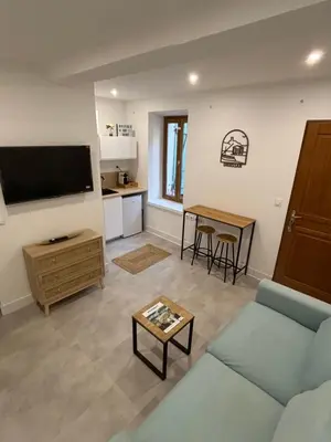 a living room with a couch and a table at Studio O Fil du Vent in Gruissan