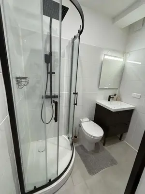 a bathroom with a shower and a toilet and a sink at Studio O Fil du Vent in Gruissan