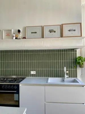 a kitchen with a sink and green tiles at Maison Hortense Carcassonne in Carcassonne