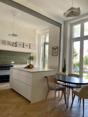 a kitchen with a table and a dining room at Maison Hortense Carcassonne in Carcassonne