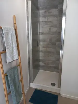 a shower with a glass door in a bathroom at Large studio near medieval city in Carcassonne