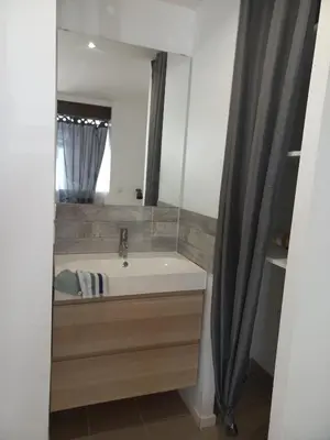 a bathroom with a sink and a large mirror at Large studio near medieval city in Carcassonne