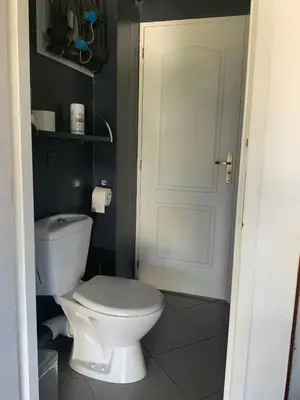 a bathroom with a white toilet and a door at Gite belle vue in Olargues