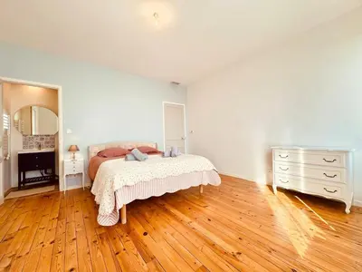 a bedroom with a bed and a dresser and a mirror at À 1min d'une base nautique Maison spacieuse avec piscine in Puicheric