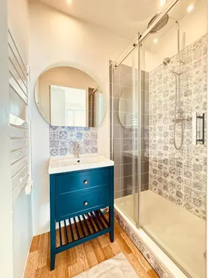 a bathroom with a blue sink and a shower at À 1min d'une base nautique Maison spacieuse avec piscine in Puicheric