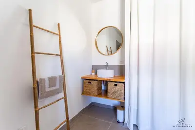 a bathroom with a sink and a mirror at Clos de la Pounso in Lapalme