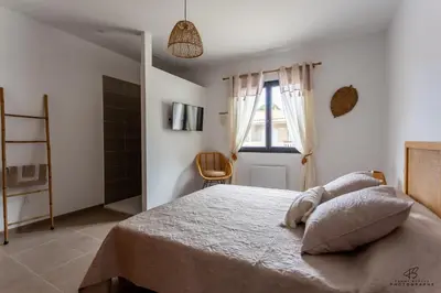 a bedroom with a bed and a window at Clos de la Pounso in Lapalme