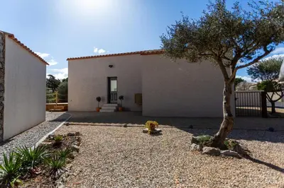 a house with a tree in front of it at Clos de la Pounso in Lapalme