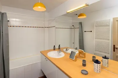 a bathroom with a sink and a mirror at Loft Sénéchal - Rare Elegance in Carcassonne