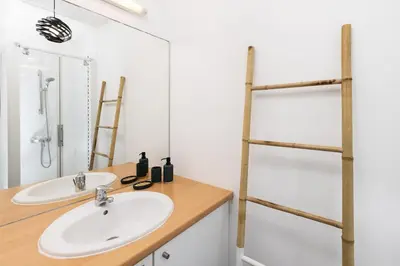 a bathroom with a sink and a mirror at Loft Sénéchal - Rare Elegance in Carcassonne