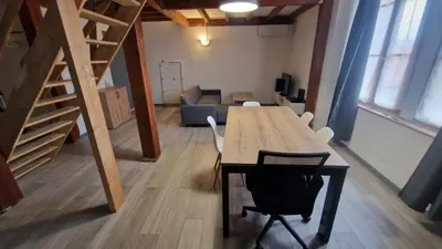 a room with a table and chairs and a couch at Appartement T3 proche centre-ville NARBONNE in Narbonne