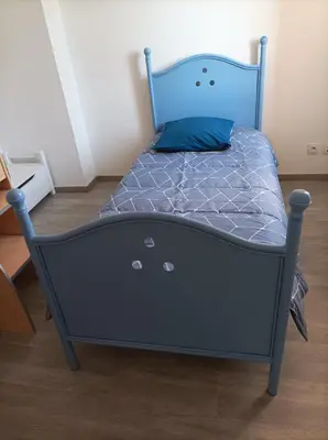 a bed with a blue bed frame in a room at Chez Sabine la Campagne HAUT in Narbonne
