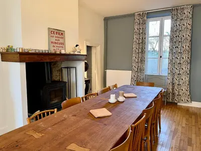 a dining room with a large wooden table and chairs at Domaine Riplou - Maison de Campagne avec piscine in Verdun-en-Lauragais