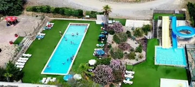 a swimming pool in a yard with cactuses at Camping 3 étoiles - Piscine - ccb0ffa in Fabrezan