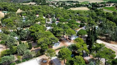 a bedroom with a bed with two pillows on it at Camping 3 étoiles - Piscine - ccb0ffa in Fabrezan