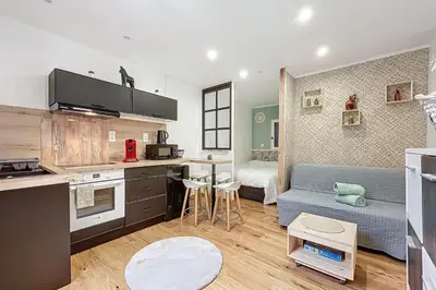 a kitchen and living room with a couch and a table at Charming studio near the city center of Narbonne in Narbonne