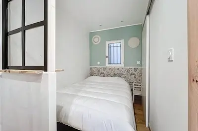 a small bedroom with a bed and a window at Charming studio near the city center of Narbonne in Narbonne