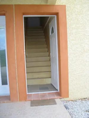 an open door with stairs in a building at Gites des Camparros in Nailloux