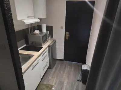 a small kitchen with a sink and a microwave at Mas Dels Caminhs in Villepinte