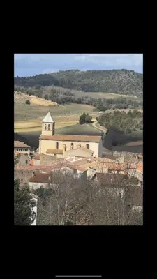 a small town with a church in the middle of a field at La maison du soleil in Villar-Saint-Anselme