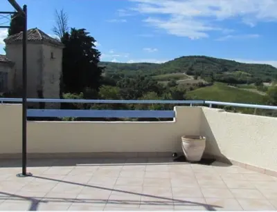 a balcony with a railing and a vase on it at La maison du soleil in Villar-Saint-Anselme