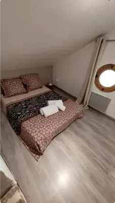 a bedroom with two beds with pillows on them at La Maison du chataignier in Cassagnolles