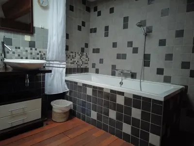 a bathroom with a bath tub and a sink at La Galinette Family Loft in Sigean