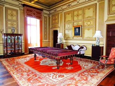 a living room with a large purple table in a room at Chateau de Paraza in Paraza