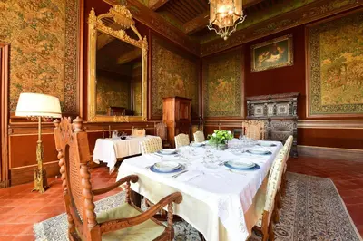 a dining room with a table with plates on it at Chateau de Paraza in Paraza