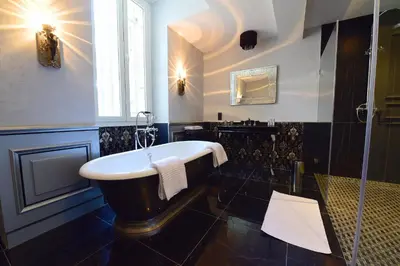 a bathroom with a bath tub and a sink at Chateau de Paraza in Paraza